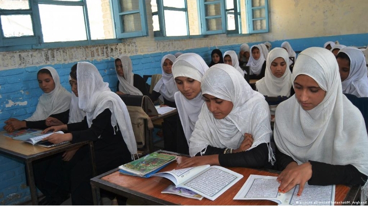 Stand With Afghan Women - Dan Ojowa - Flickr Girls sitting in a classroom with books on their tables.