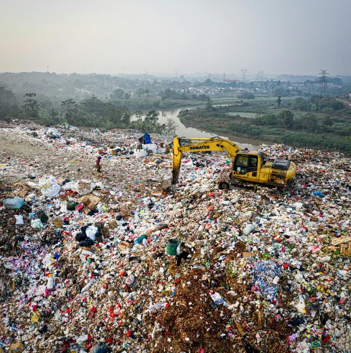 Digger on top of a landfill