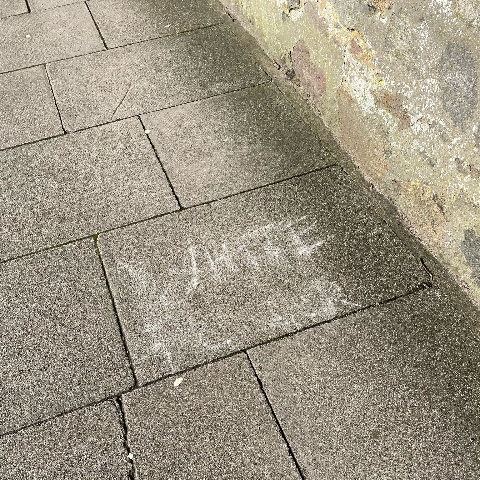 Photo: Emily McKay racist graffiti cicture; the words "WHITE POWER" written in chalk on a pavement in University of Aberdeen
