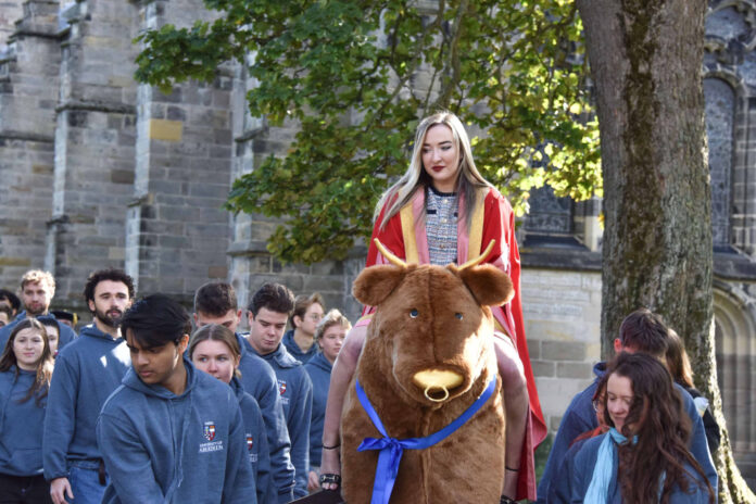 Iona Fyfe rides a 'bull' at her installation ceremony (Source: University of Aberdeen)