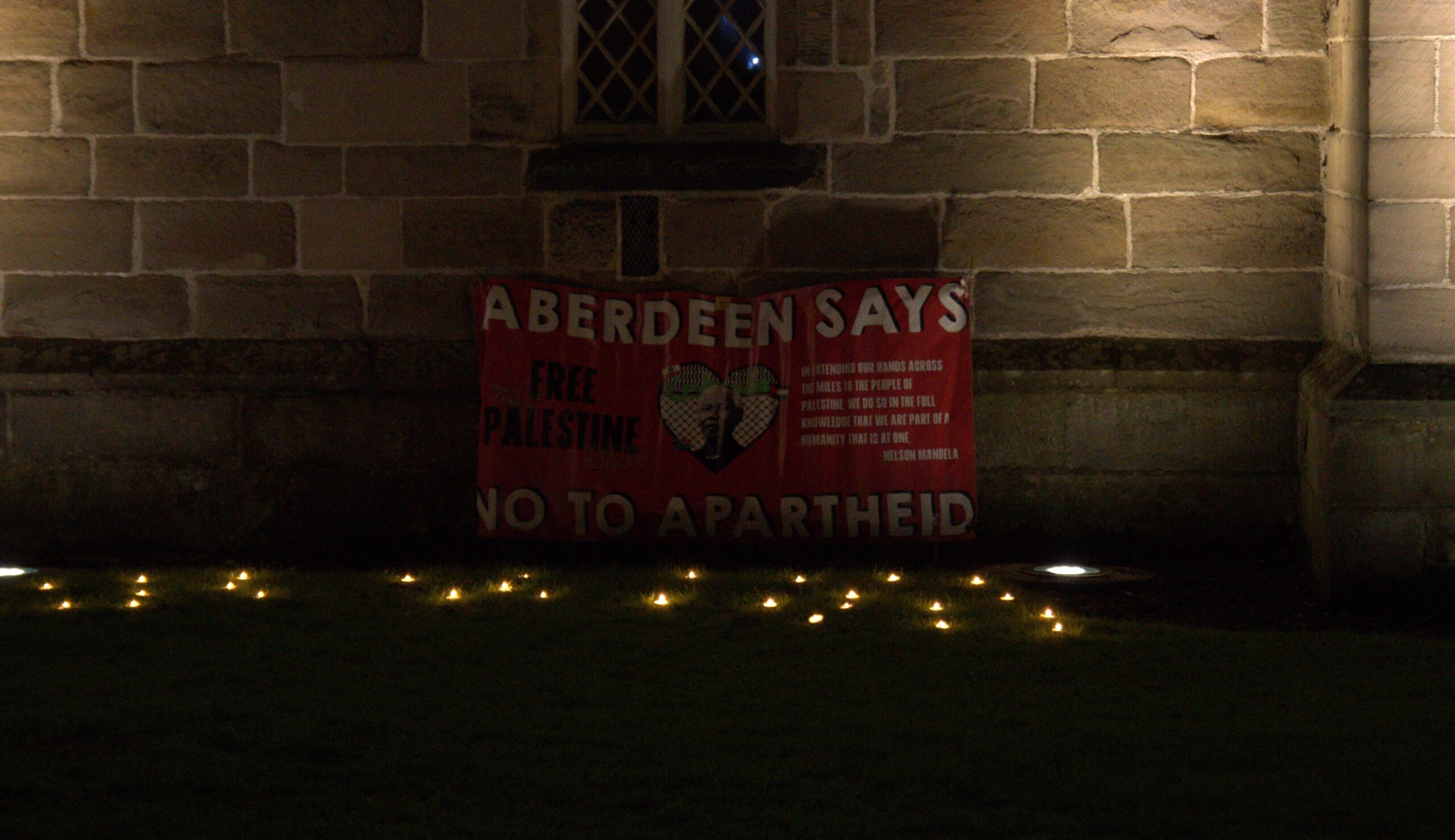 A poster reading 'ABERDEEN SAYS NO TO APARTHEID' by King's College Chapel (Photo: Jie Chong)