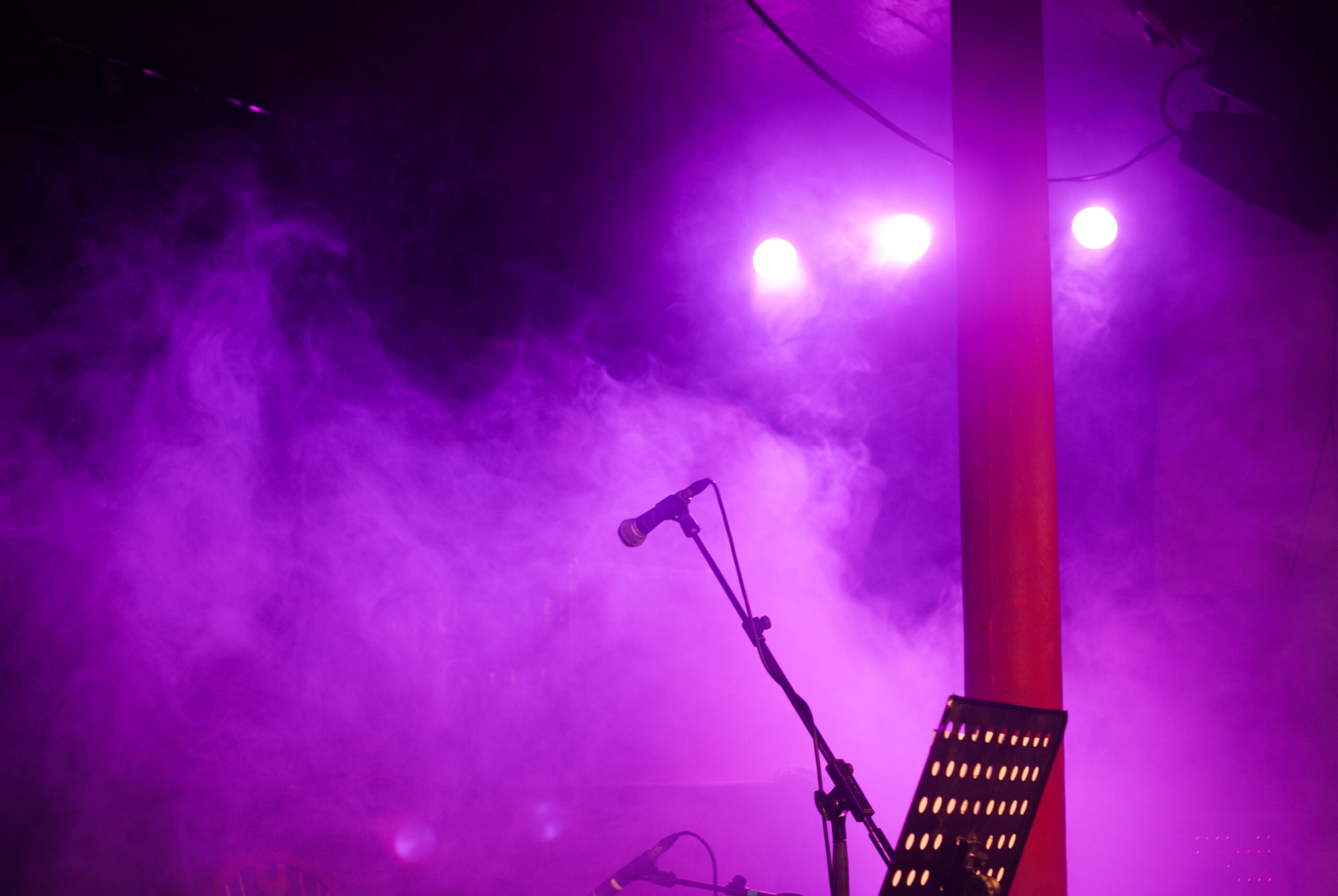 photograph of a microphone on stage via The Gaudie