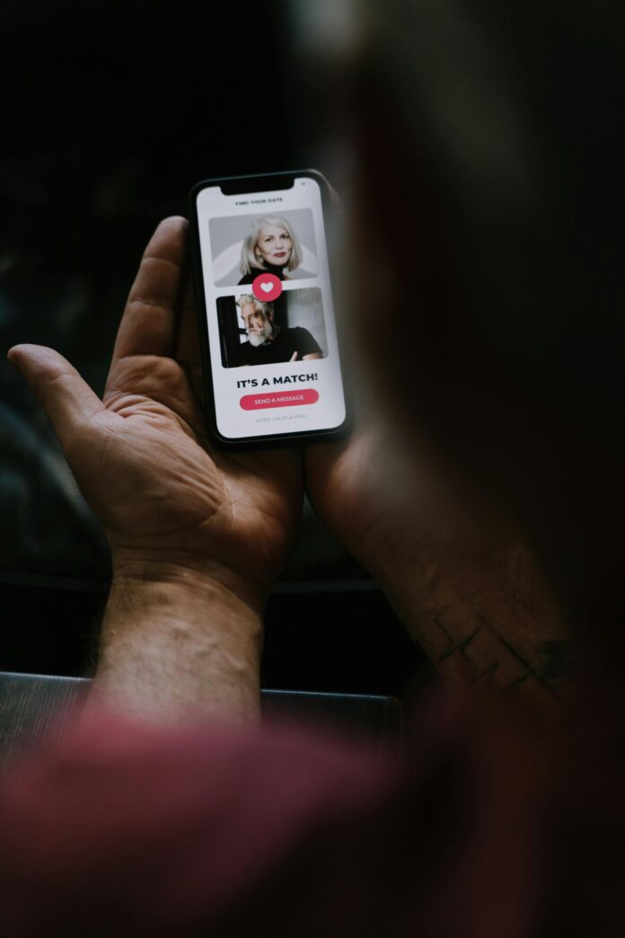 Person holding phone with dating app saying 