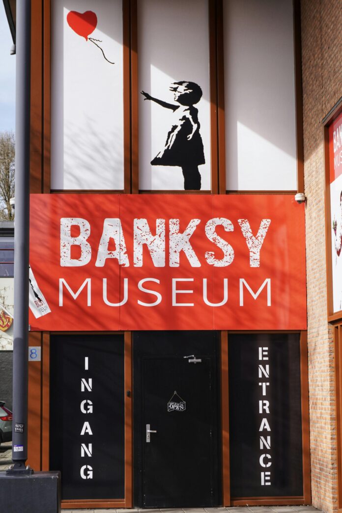 Banksy Museum entrance with 'girl with balloon' artwork above the door.